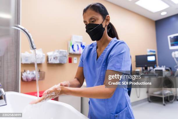 healthcare worker washing hands in a medical clinic - prevention stock pictures, royalty-free photos & images
