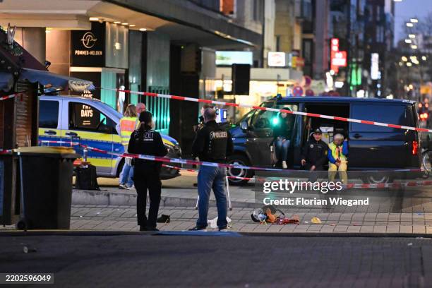 Police officer seen near the suspected crime scene after a car was driven into pedestrians on March 3, 2025 in Mannheim, Germany. One person is...