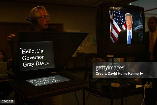 Governor Gray Davis appears on a monitor, as he waits to tape a message from his office in the Capitol Building July 16, 2003 in Sacramento, CA. The...