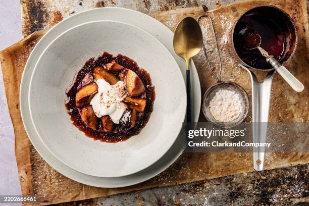 baked plums - rode bes stockfoto's en -beelden