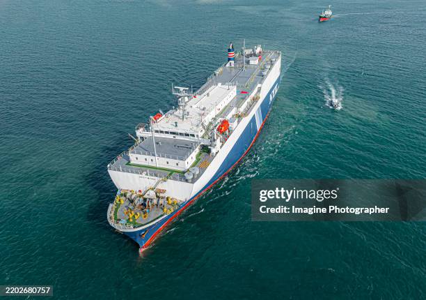aerial view, large ship running out the cargo port. transportation by car barge to foreign countries business of transporting ready-made cars by sea transport. - bay showroom stock pictures, royalty-free photos & images