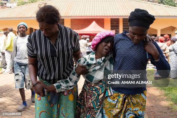 Family members comfort a grieving family member in Bukavu on March 4, 2025 during funeral proceedings of victims of the February 27, 2025 explosions...