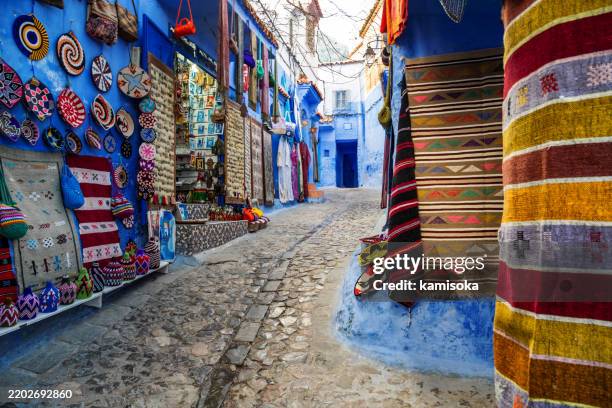colorful artisan bazaar in the blue alleys of chefchaouen, morocco - loom stock pictures, royalty-free photos & images