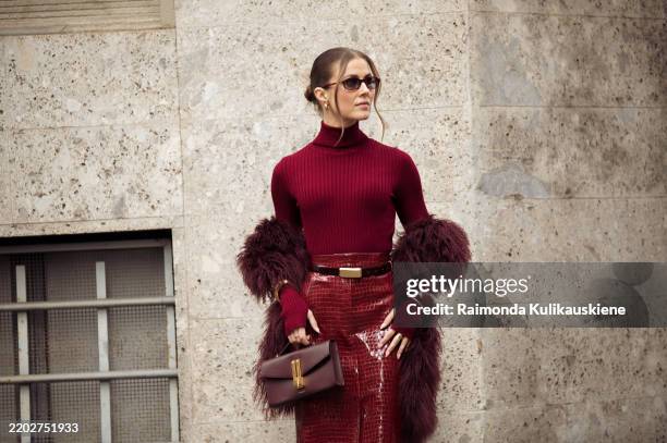 Nina Sandbech wears burgundy pencil skirt with reptile print, burgundy turtleneck, belt, burgundy bag, golden statement bracelets during the Milan...