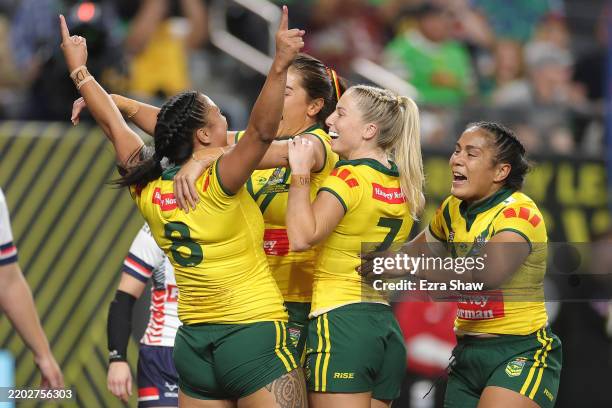 Shannon Mato of Australia celebrates with team mates after scoring a try during the International Match between the Australia Jillaroos and England...