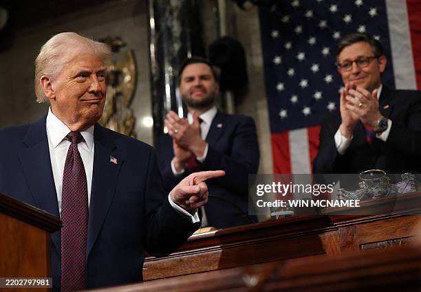 Vice President JD Vance and Speaker of the House Mike Johnson applaud as US President Donald Trump speaks during an address to a joint session of...