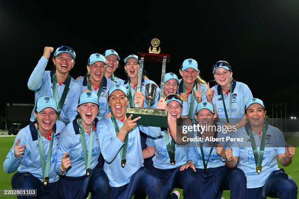 New South Wales celebrate with the trophy during the WNCL Final match between Queensland and New South Wales at Allan Border Field, on March 02 in...