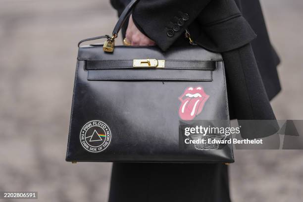 Close-up view of a bag from Hermes with Pink Floyd, Rolling Stones, Aerosmith, rock music stickers details, outside Dolce & Gabbana, during the Milan...