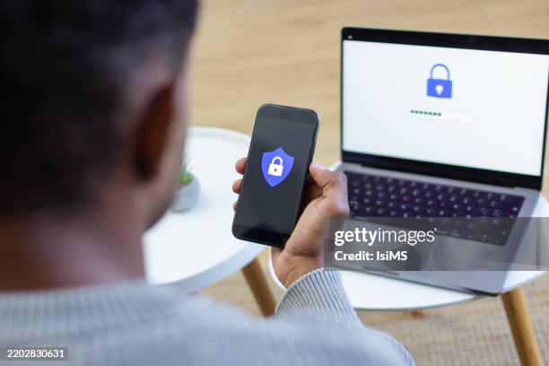 man using two-factor authentication on smartphone and laptop - security code stock pictures, royalty-free photos & images