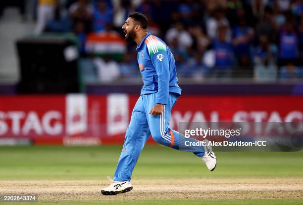 Varun Chakravarthy of India celebrates after taking the wicket of Michael Bracewell of New Zealand during the ICC Champions Trophy 2025 match between...