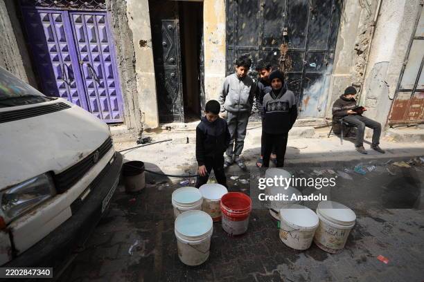 Palestinians, who go through a water crisis due to Israel's blocking of fuel from the Kerem Abu Salim border crossing, which has disrupted the supply...
