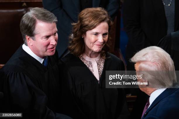 Supreme Court Justices Brett Kavanaugh and Amy Coney Barrett greet President Donald Trump after his address to a joint session of Congress in the...