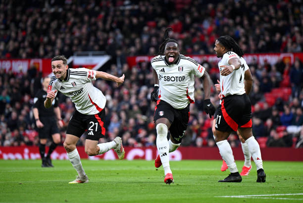 Calvin Bassey of Fulham celebrates scoring his team's first goal with teammates Timothy Castagne and Adama Traore during the Emirates FA Cup Fifth...