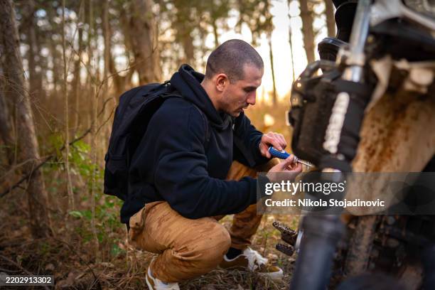 preparing my motorbike for a long ride - schroevendraaier stockfoto's en -beelden
