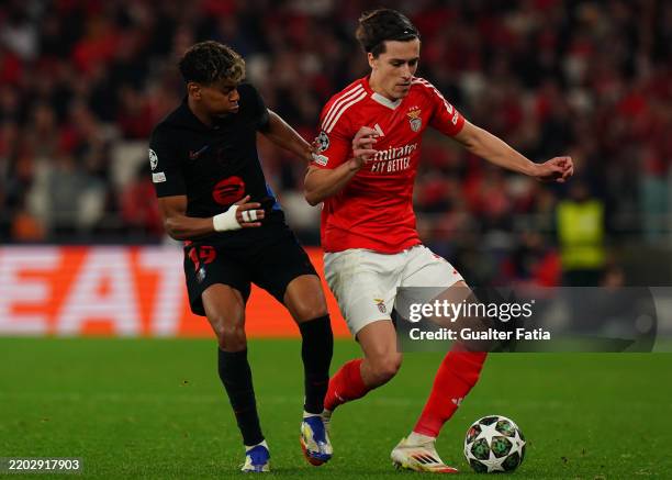 Alvaro Carreras of SL Benfica with Lamine Yamal of FC Barcelona in action during the UEFA Champions League 2024/25 Round of 16 First Leg match...