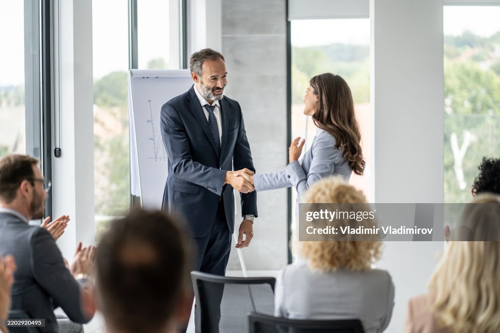 Handshake In Office Professional Handshake In A Corporate Office Meeting High-Res Stock ...