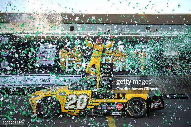 Christopher Bell, driver of the DEWALT Toyota, celebrates in victory lane after winning the NASCAR Cup Series EchoPark Automotive Grand Prix at...