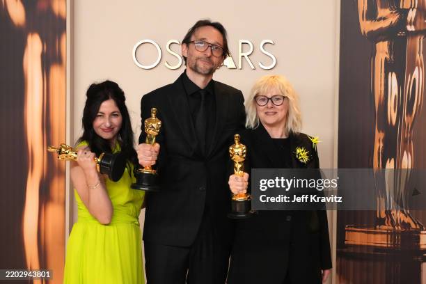 Marilyne Scarselli, Pierre Olivier Persin, and Stéphanie Guillon, winners of the Best Makeup and Hairstyling for “The Substance”, pose in the press...