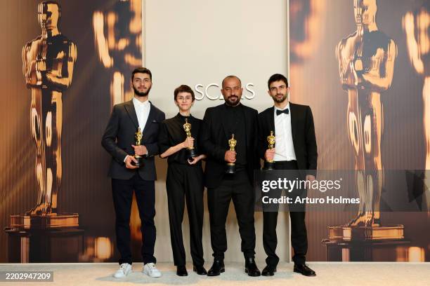 Yuval Abraham, Rachel Szor, Hamdan Ballal, Basel Adra, winners of the Best Documentary Feature Film for “No Other Land”, pose in the press room...
