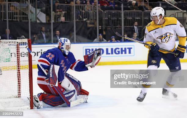 Jonathan Quick of the New York Rangers makes the third period save as Michael McCarron of the Nashville Predators looks for the rebound at Madison...
