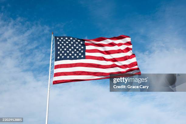 american flag blows in the wind - fahnenstange stock-fotos und bilder