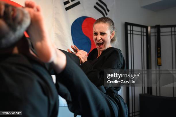 physical self defense - female martial arts stock pictures, royalty-free photos & images