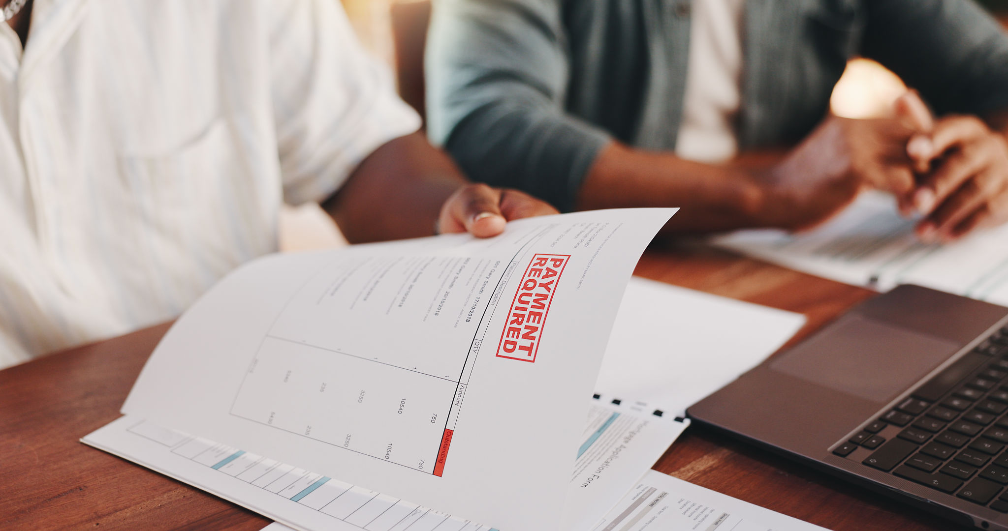 Document, hands and people in home with debt, financial planning or tax invoice for mortgage loan. Bank expenses, paperwork and men help with bills, payment statement and reminder with fees closeup Document, hands and people in home with debt, financial planning or tax invoice for mortgage loan. Bank expenses, paperwork and men help with bills, payment statement and reminder with fees closeup