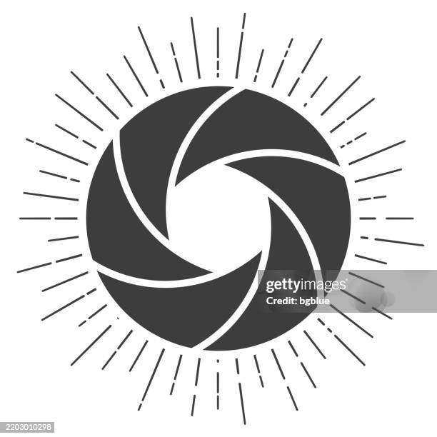 camera shutter. icon with sunbursts on white background - camera aperture stock illustrations