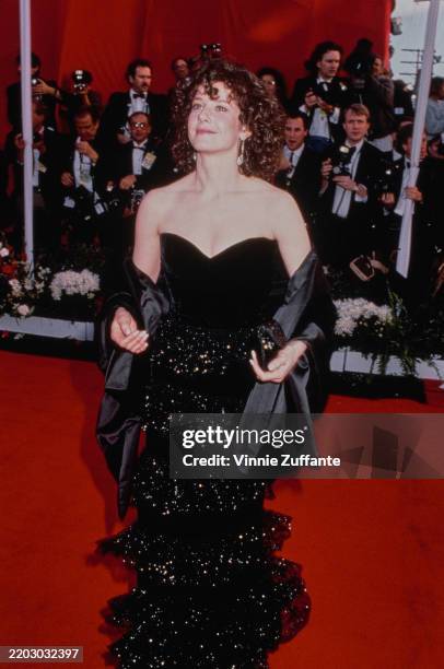 American actress Debra Winger, wearing a strapless black evening gown with a black evening wrap, attends the 63rd Academy Awards at the Shrine...