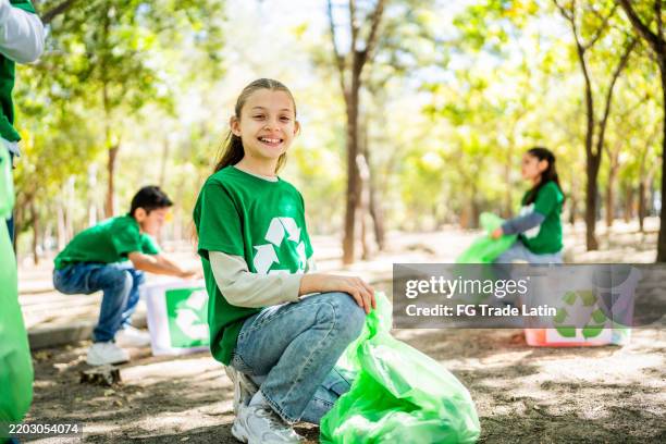 portrait of a child recycler girl cleaning the public park - environmentalist stock pictures, royalty-free photos & images