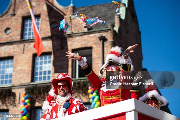 Carnivalists throw sweets during the annual Rose Monday parade during carnival on March 03, 2025 in Dusseldorf, Germany. Rose Monday, the highpoint...