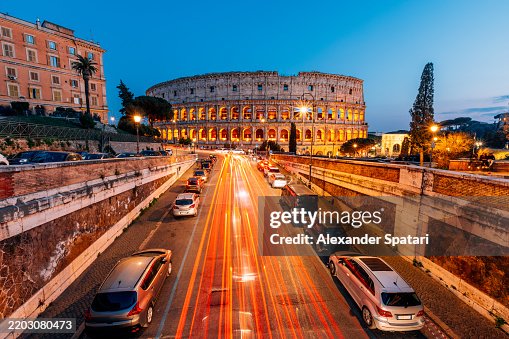 Coliseum and Rome skyline illuminated at dusk, elevated view, Lazio, Italy Coliseum and Rome skyline illuminated at dusk, elevated view, Lazio, Italy