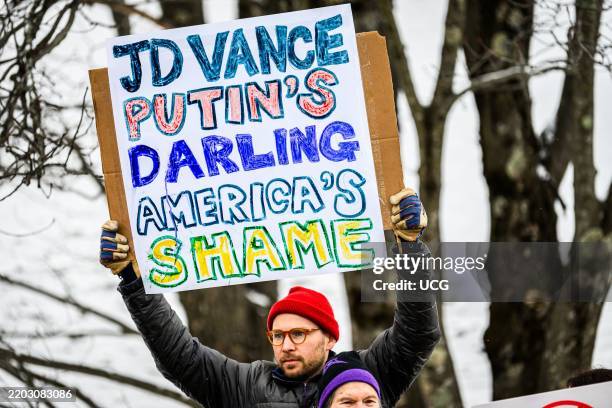 Demonstrators line Route 100 in Waitsfield, Vermont, to protest the visit of Vice President J.D. Vance to Vermont on a ski vacation at nearby...