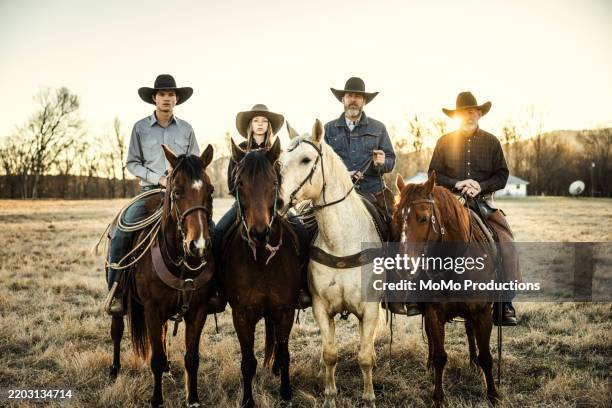 portrait of multi-generational family of cowboys at sunset - old western cowboy stock pictures, royalty-free photos & images