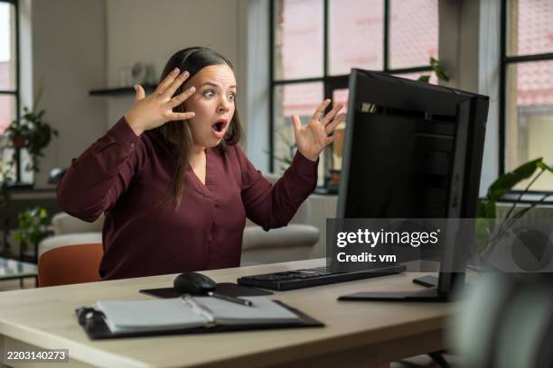 frustrated woman reacting to computer screen in home office setting - hormone stock pictures, royalty-free photos & images