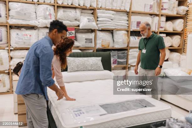 couple testing a mattress for comfort and support - mattress stock pictures, royalty-free photos & images