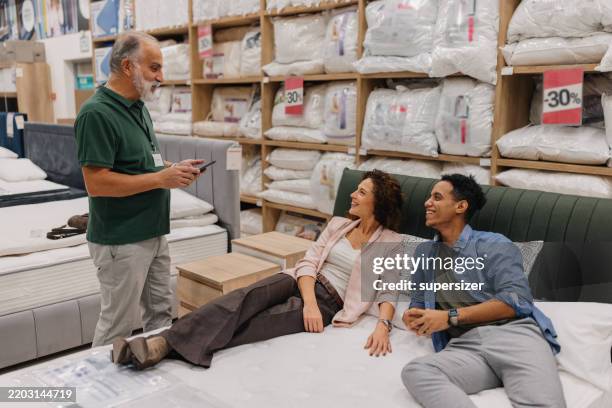 product consultation inside a bedding store - mattress stock pictures, royalty-free photos & images