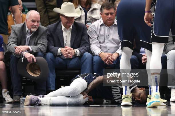 Kyrie Irving of the Dallas Mavericks lies on the court after suffering an injury in the first half against the Sacramento Kings at American Airlines...