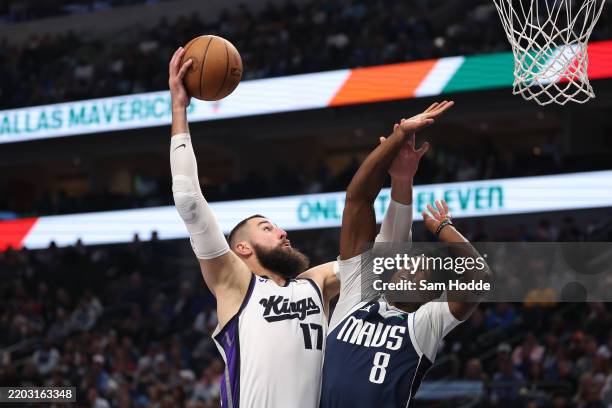 Jonas Valanciunas of the Sacramento Kings goes up for a shot against Olivier-Maxence Prosper of the Dallas Mavericks during the first half at...