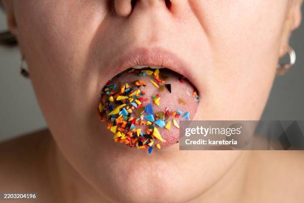 close-up of woman tongue with microplastic particles - mikroplastik stock-fotos und bilder