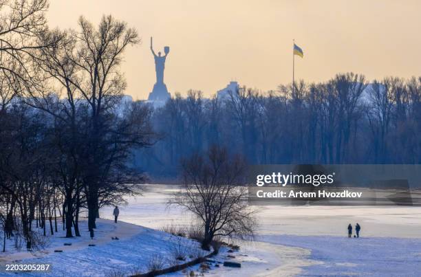 majestic mother ukraine monument rising above frosty kyiv during a serene winter's day - dnieper river stock pictures, royalty-free photos & images