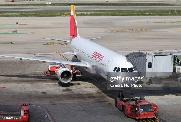 An Iberia Airbus A321-212 disembarks at the Barcelona-El Prat airport terminal, assisted by an autonomous ambulift, in Barcelona, Spain, on March 5,...