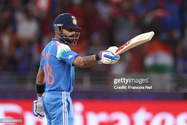 Virat Kohli of India salutes the crowd after reaching his half century during the ICC Champions Trophy 2025 semi final between India and Australia at...
