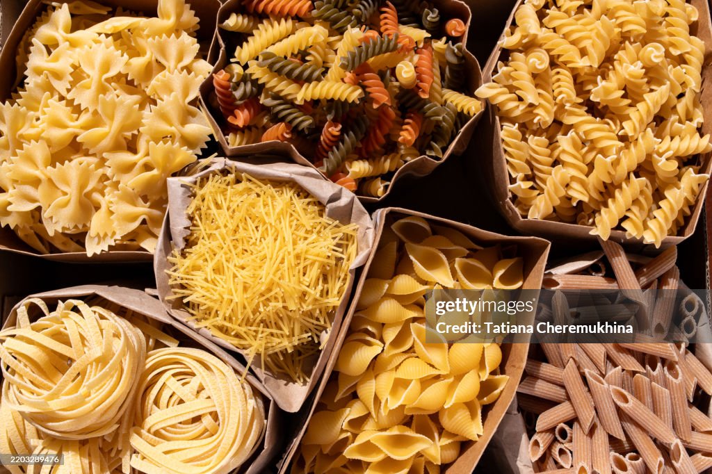 Assorted pasta in kraft paper bags, top view