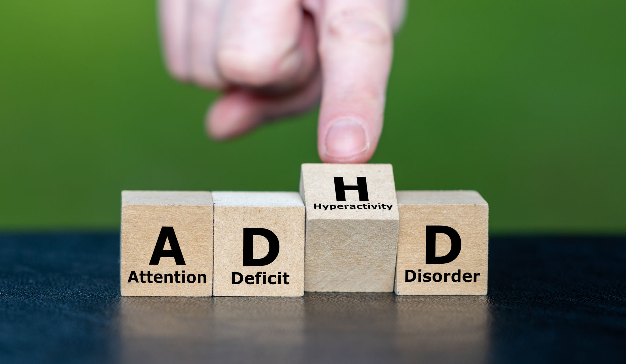 Hand turns cube and changes the acronym ADD (Attention Deficit Disorder) to ADHD (Attention Deficit Hyperactivity Disorder) Hand turns cube and changes the acronym ADD (Attention Deficit Disorder) to ADHD (Attention Deficit Hyperactivity Disorder)