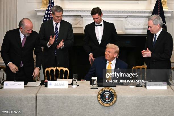 President Donald Trump , flanked by US Secretary of Commerce Howard Lutnick , US Secretary of Treasury Scott Bessent and White House AI and Crypto...