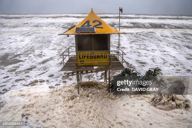 Lifeguard tower is surrounded by water on Main Beach that has been damaged by record-breaking waves caused by the outer fringe of Tropical Cyclone...