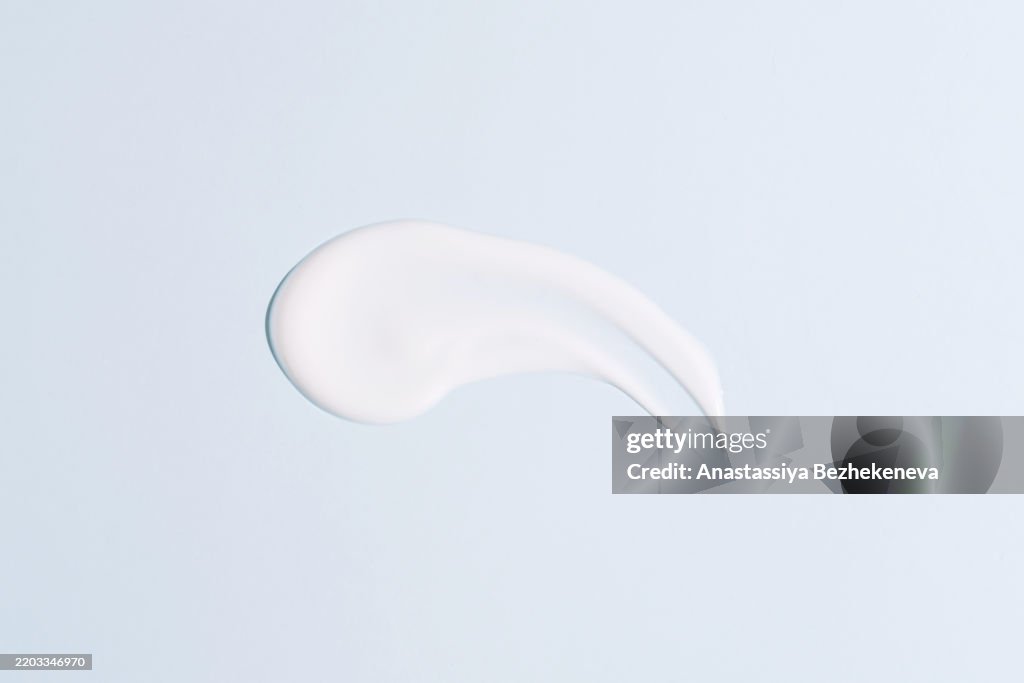 One smear of cream on a blue background cosmetics