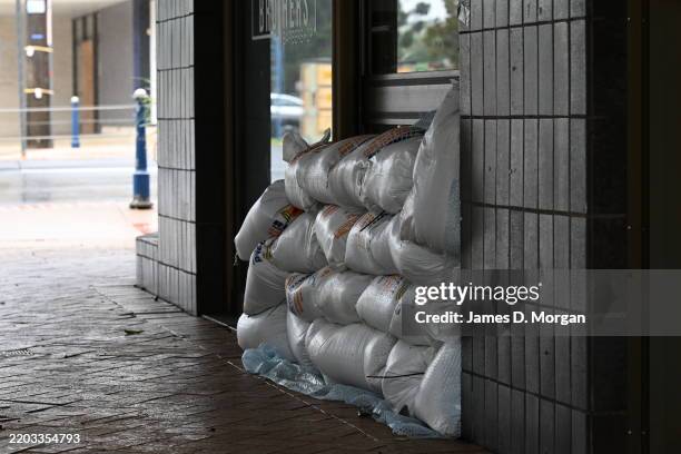 Pile of sandbags protects a barber shop from floodwater on March 05, 2025 in Lismore, Australia. Tropical Cyclone Alfred is expected to make landfall...