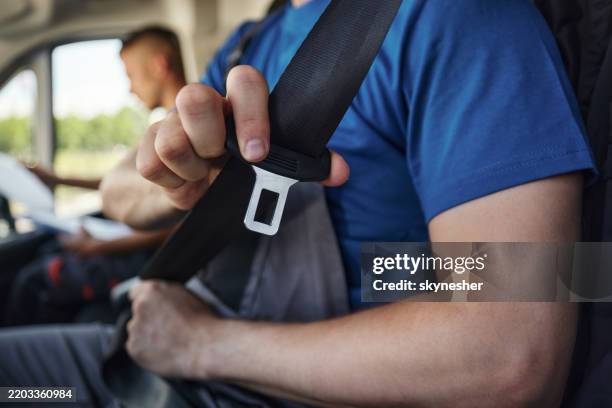 close up of fastening seat belt. - seat belt stock pictures, royalty-free photos & images